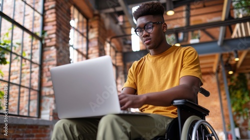 Young Man Using Laptop in Wheelchair © MP Studio