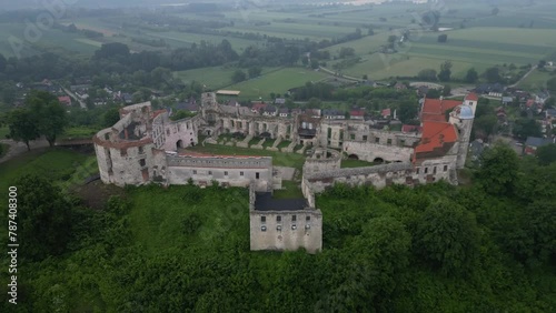 Drone view of the bastion castle on a steep Vistulan hillside in agricultural field on a foggy day photo