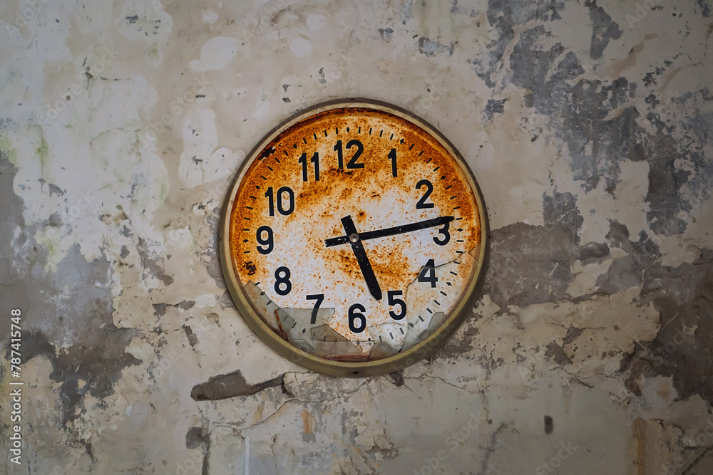 Old broken rusty wall clock in an abandoned building in Pripyat, Chornobyl Exclusion zone, Ukraine Old broken rusty wall clock in an abandoned building in Pripyat, Chornobyl Exclusion zone, Ukraine