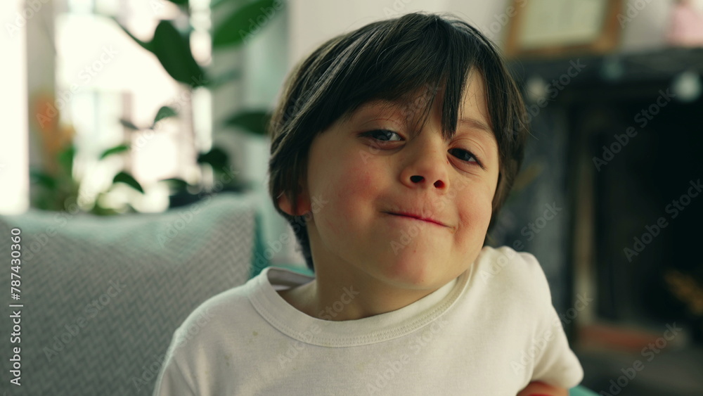 Young 5 year old boy portrait seated at home couch, close-up face of joyful male caucasian kid Young 5 year old boy portrait seated at home couch, close-up face of joyful male caucasian kid