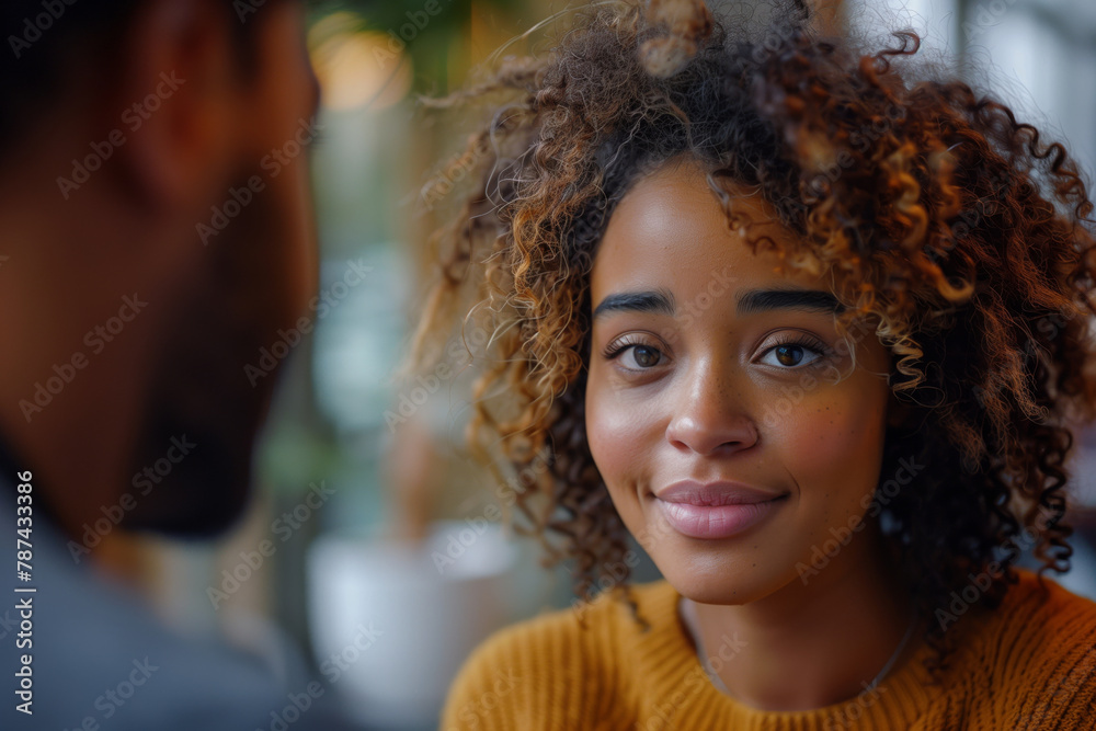 A young woman with curly hair smiles during a conversation, her eyes reflecting a sense of happiness and engagement. AI Generated A young woman with curly hair smiles during a conversation, her eyes reflecting a sense of happiness and engagement. AI Generated