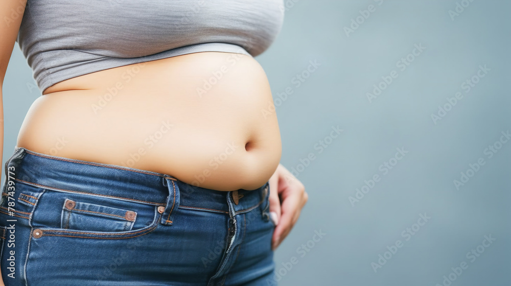 Woman lower body with fat belly curvy hips overweight in jeans. Weight loss healthy diet plastic surgery body positive self-love concept Woman lower body with fat belly curvy hips overweight in jeans. Weight loss healthy diet plastic surgery body positive self-love concept