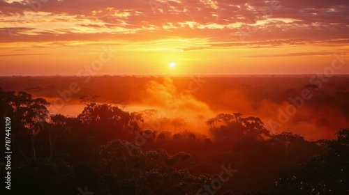 A breathtaking image capturing the sunrise over a dense, misty tropical forest with vibrant colors