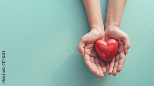 hands holding a red heart shape against a soft blue background love and care concept