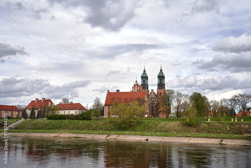 Historic buildings and towers of the cathedral on the river Warta in the city of Poznan