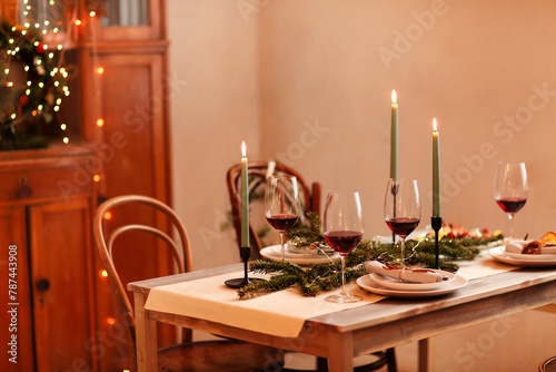 Candles and wine on Christmas table