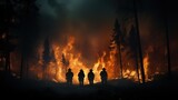 Silhouette of a group of people standing in the middle of a forest fire