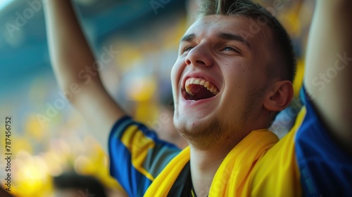 A happy fan in a yellow shirt is celebrating with a gesture, smiling and screaming in the air, enjoying the fun event surrounded by a lively crowd. AIG41