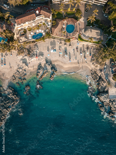 Vertical aerial view of Conchas Chinas Beach in PV Mexico showing clear turquoise water in ocean