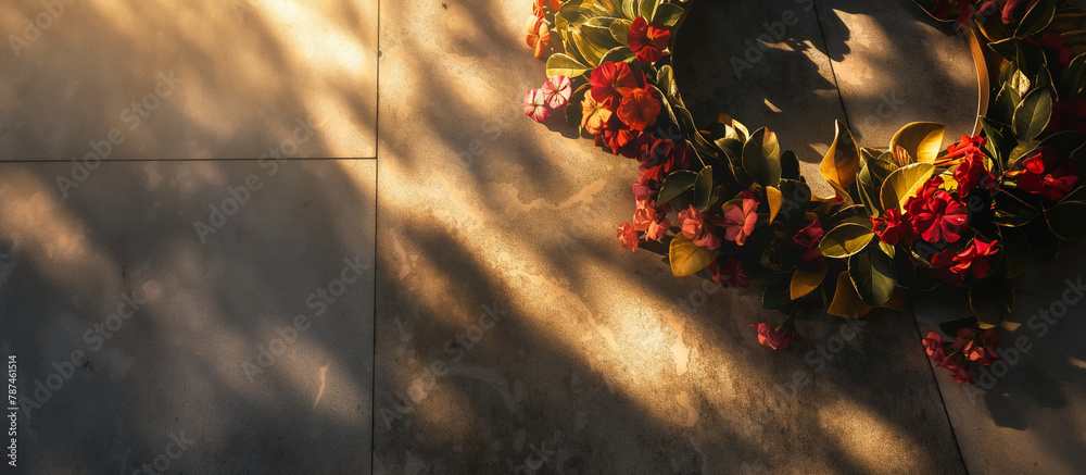 A ceremonial wreath being laid at a war memorial, with soft light casting a solemn shadow to symbolize honor and remembrance. Memorial Day, Independence Day , with copy space - obrazy, fototapety, plakaty 