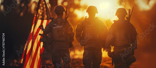 A banner featuring soldier silhouettes with the American flag in the background, highlighted by the soft glow of sunset. Memorial Day, Independence Day , with copy space
