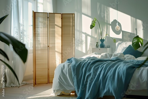 Stylish interior of modern bedroom with wooden folding screen photo