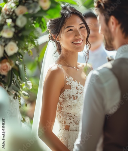 Elegant Asian woman in a wedding dress under a floral arch