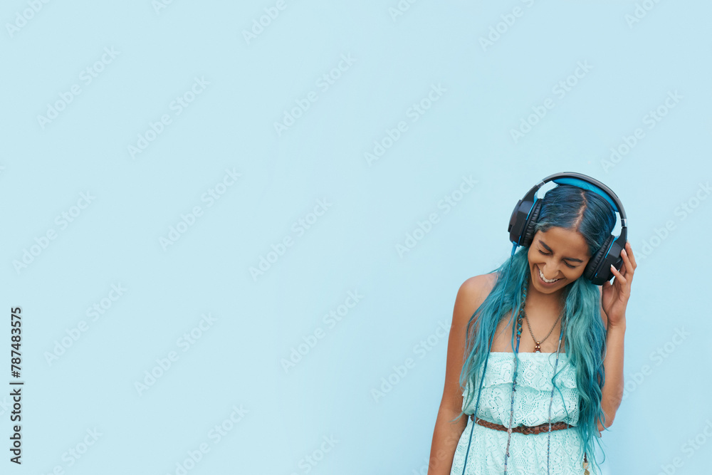 Woman, headphones and laugh with music, mockup space and blue wall background on campus. Student, positivity and podcast audio or radio for education, college and confidence for university break Woman, headphones and laugh with music, mockup space and blue wall background on campus. Student, positivity and podcast audio or radio for education, college and confidence for university break