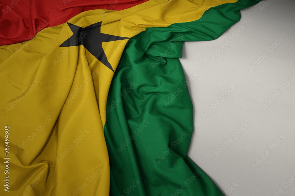 waving national flag of ghana on a gray background.