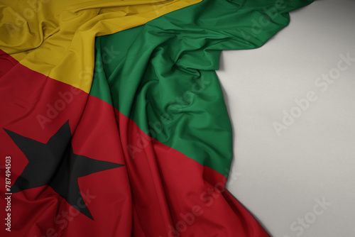 waving national flag of guinea bissau on a gray background.