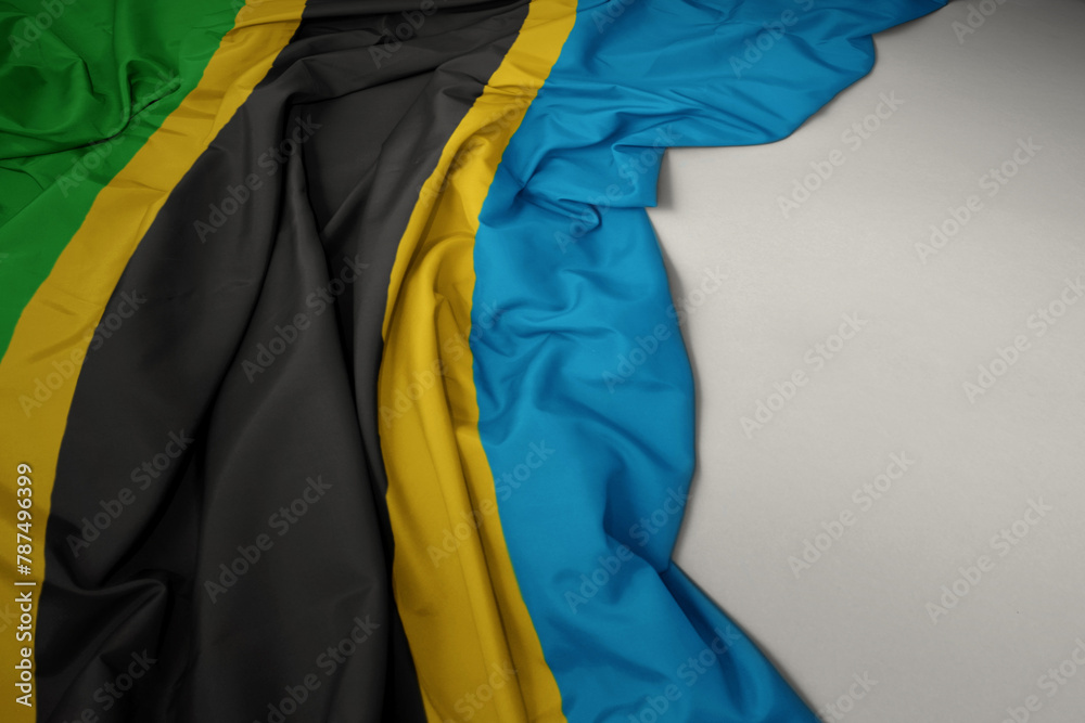 waving national flag of tanzania on a gray background.