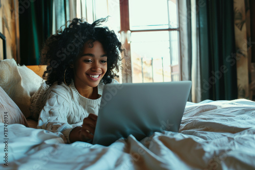 Woman Laying in Bed Using Laptop