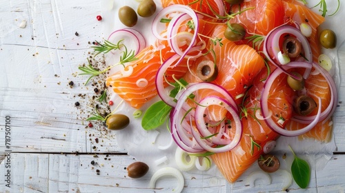 Salmon and white fish salad with onions and olives arrangement on a white wooden surface photo