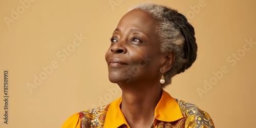 Joyful African American elderly woman with a heartwarming smile, wearing a yellow sweater and cultural jewelry, radiates happiness against a soothing background.
