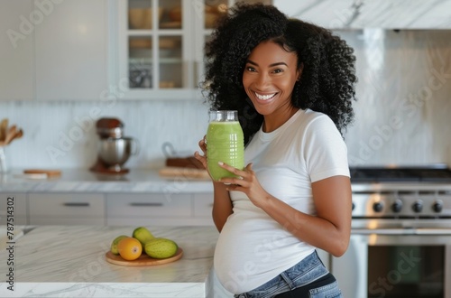 Pregnant Woman Holding Green Smoothie in Kitchen