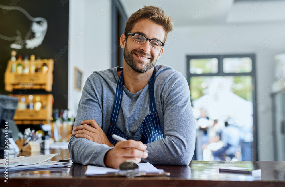Fototapeta premium Happy businessman or coffee shop owner with documents or agenda for planning menu and recipes in cafe. Male entrepreneur, paperwork and smile for research, ideas and budget review in restaurant