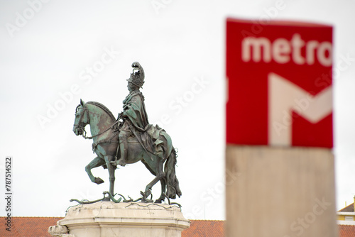 Red defocused subway station identification symbol with the knight D.JoséI  in the background photo