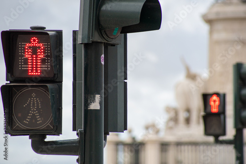 Red pedestrian crossing traffic light with blurred background of another traffic light