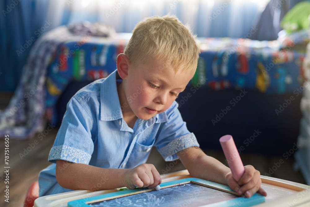 Home, boy and writing on chalkboard, child development and fun activity with education or carefree. Artwork, house and kid with idea or smile with student or hobby for learning, drawing or creativity Home, boy and writing on chalkboard, child development and fun activity with education or carefree. Artwork, house and kid with idea or smile with student or hobby for learning, drawing or creativity