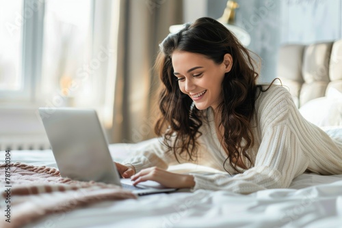 Woman Laying in Bed Using Laptop