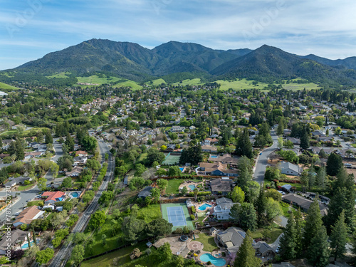 Drone landscape photos over the beautiful landscape of Clayton, California with homes, streets and green hills. photo