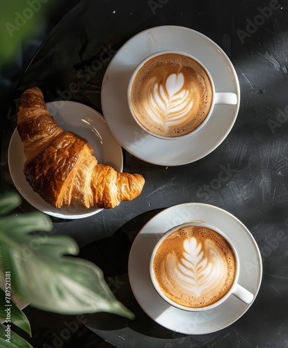 Two Cups of Coffee and a Croissant on a Table