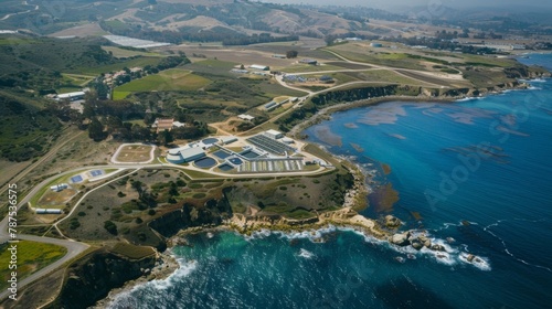 An aerial view of a sprawling research facility nestled in an idyllic coastal setting dedicated to studying and optimizing the production of algaebased biofuel. . photo