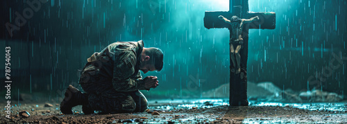 Christian man praying in front of Christian cross in the rain.
