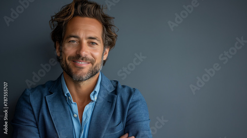 Happy young smiling confident professional business man wearing blue shirt, pretty stylish male executive looking at camera, standing arms crossed at grey background concept.