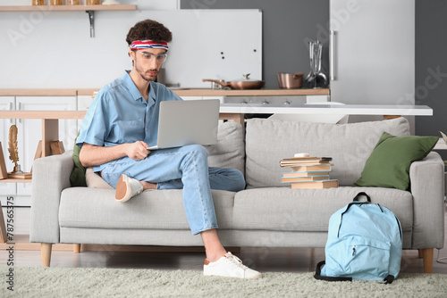 Male student studying with ...