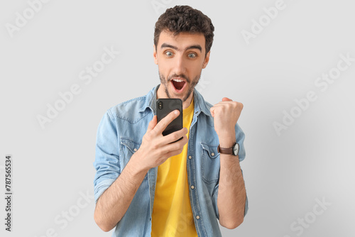 Happy young man using mobil...