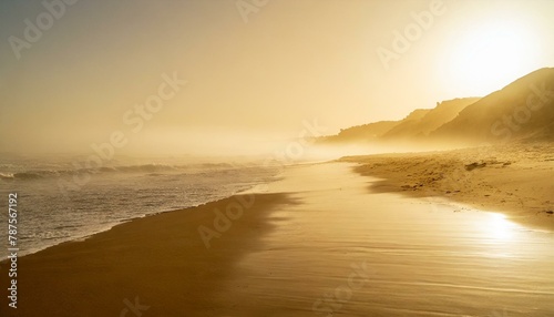 Misty morning over Mediterranean sea. Soft golden sunlight, silky sandy beach, breeze blowing. 