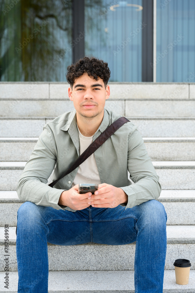 portrait of young freelancer using smartphone portrait of young freelancer using smartphone