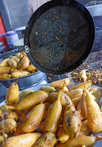 Traditional Mirch Pakoras Indian food as Samosas fried on street food and market