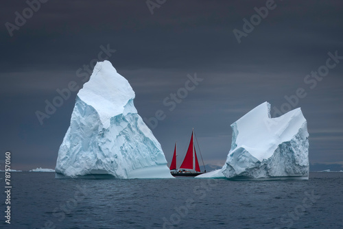 2 large icebergs with red sailboat in between, Ilulissat Greenland