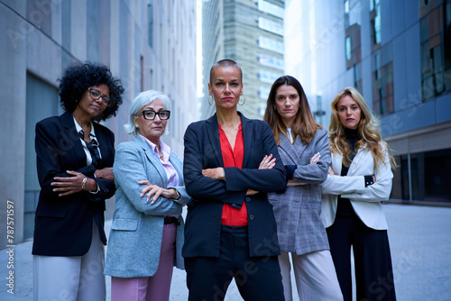 Foto Portrait of multiracial and diverse ages business women in formal suits posing serious with arms crossed looking at camera