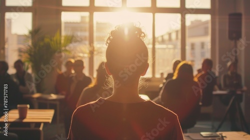 A person entering a room full of people in a meeting. Silhouettes of office people in the afternoon.