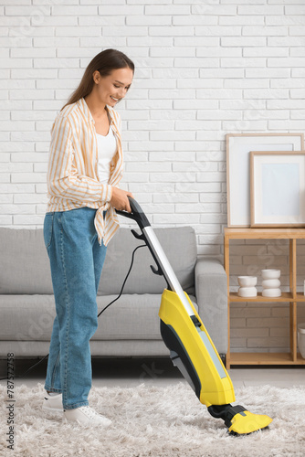Pretty young woman cleaning...