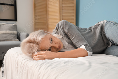 Depressed mature woman lyin...