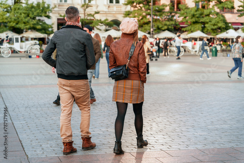 A couple in a vibrant city square, showcasing 2024 urban exploration trend, perfect for concepts of travel, lifestyle, and modern relationships