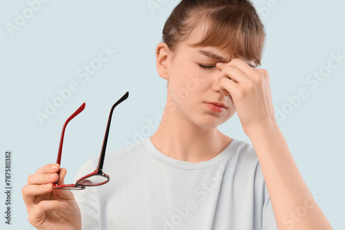 Tired young woman in eyegla...