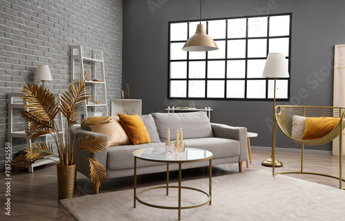 Interior of modern living room with golden decor and sofa