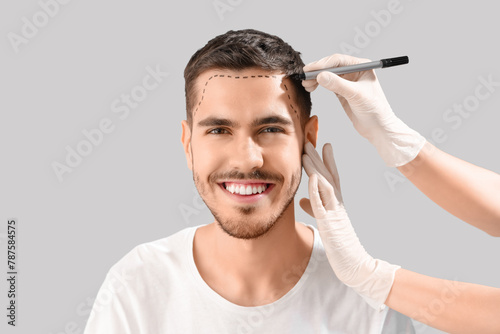 Doctor marking young man's ...