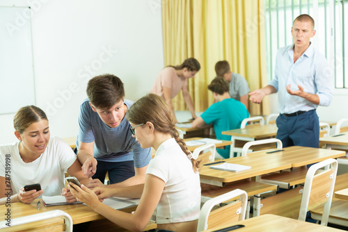 Fellow students having group work tasks during school day